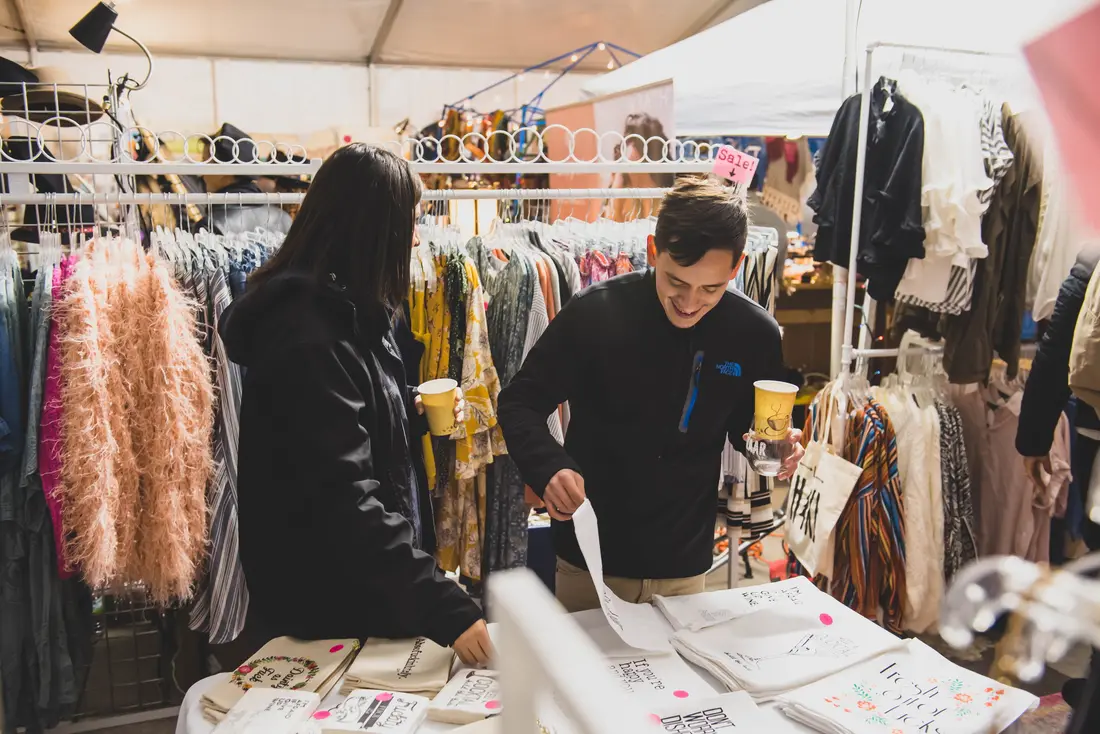 Shoppers going through racks of clothing at the RiNo Holiday BAZAAR.