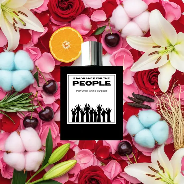 The same bottle on a bed of roses, lilies, cotton and a cut orange.