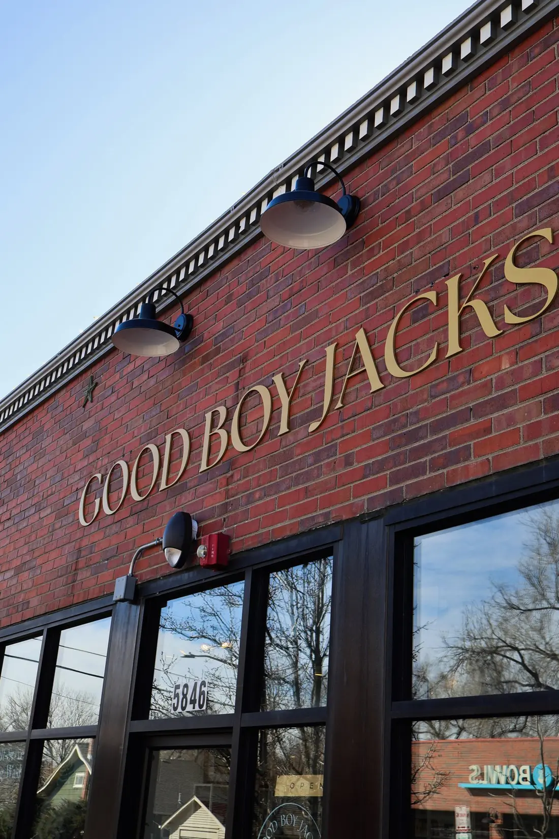 The Good Boy Jacks sign on a red brick storefront.