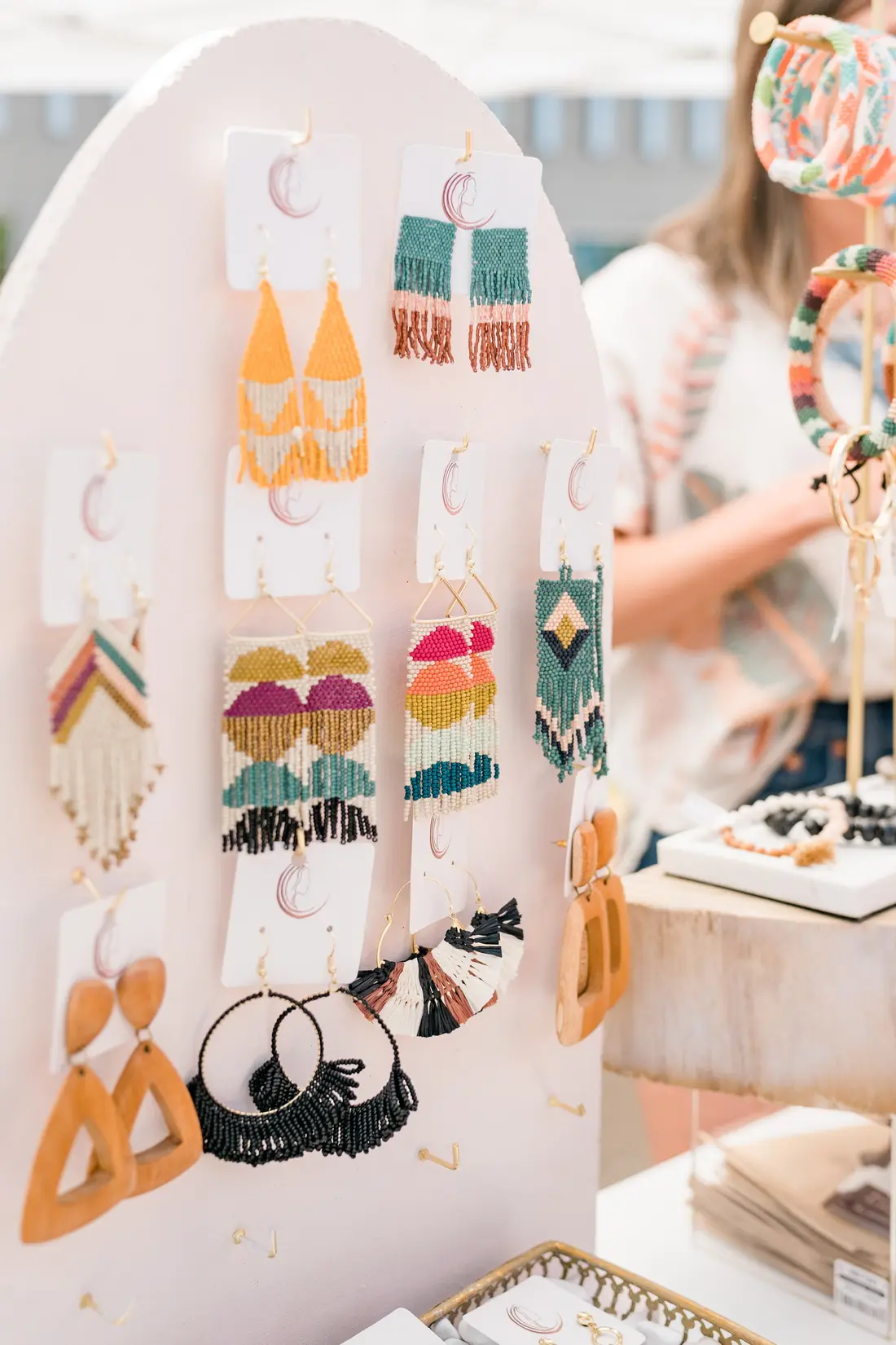 Earrings pinned to a board on a maker’s table at the RiNo Spring BAZAAR.