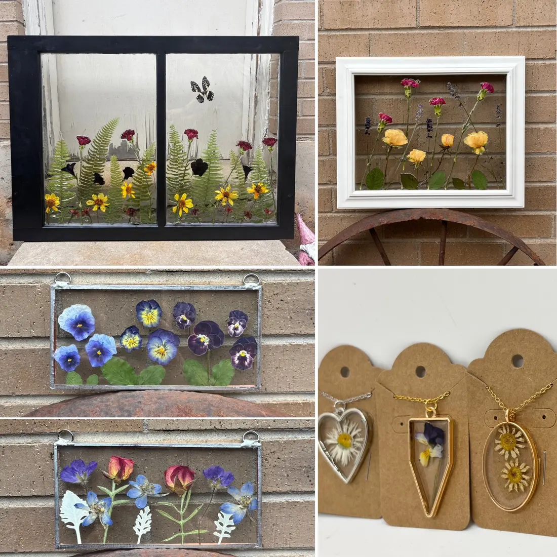 Pressed wildflowers set in small window frames and two gold-rimmed pendants, laid out on a tabletop.