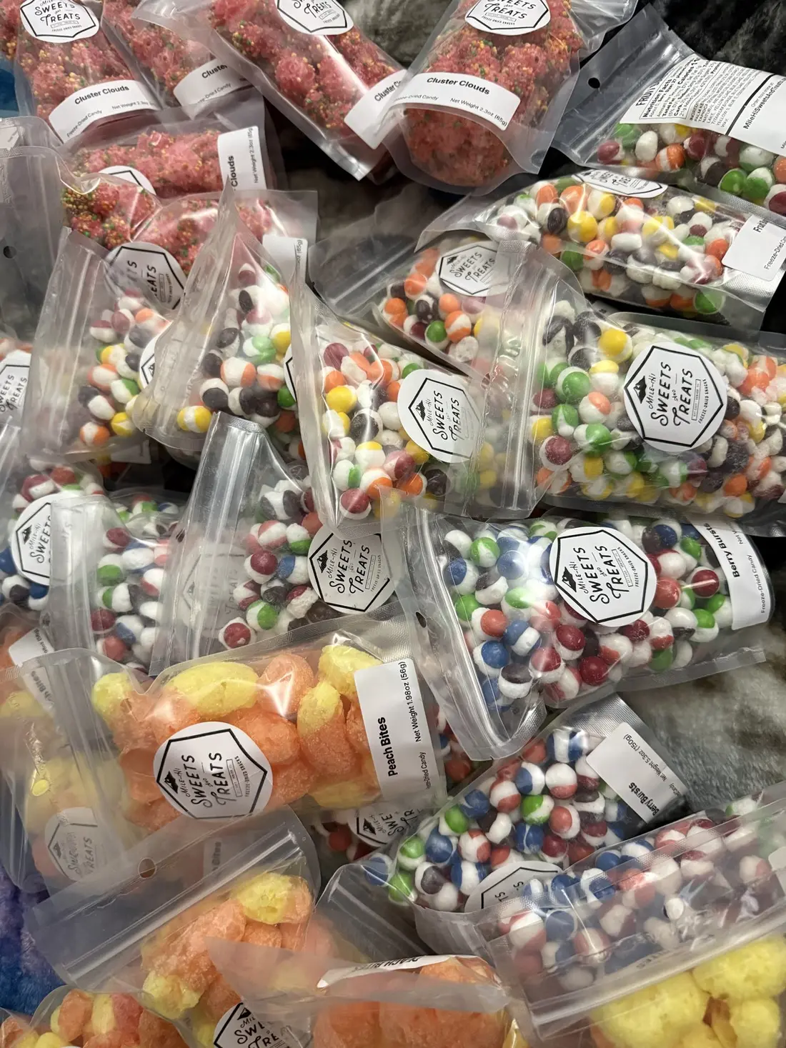 Clear packs of brightly colored freeze-dried candy in a pile.