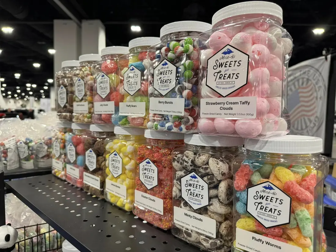 Jars of freeze-dried candy lined up on a shelf.
