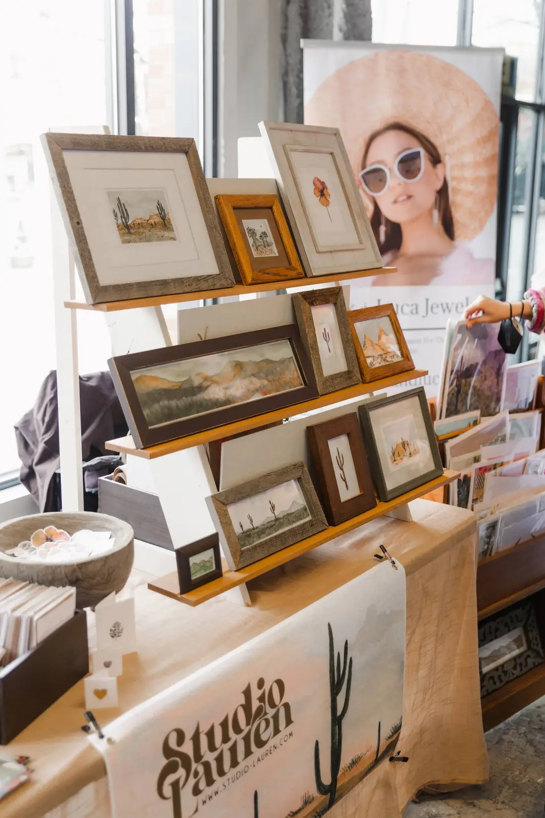 Framed prints lined up on a maker’s table at the Valentine’s BAZAAR.