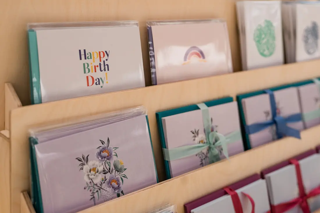 Greeting cards in a wooden display at the RiNo Spring BAZAAR.