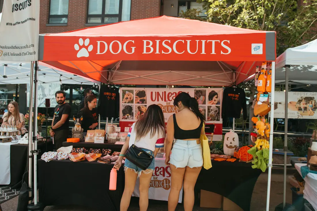Shoppers at a dog biscuit tent at the Belleview Station Fall BAZAAR.